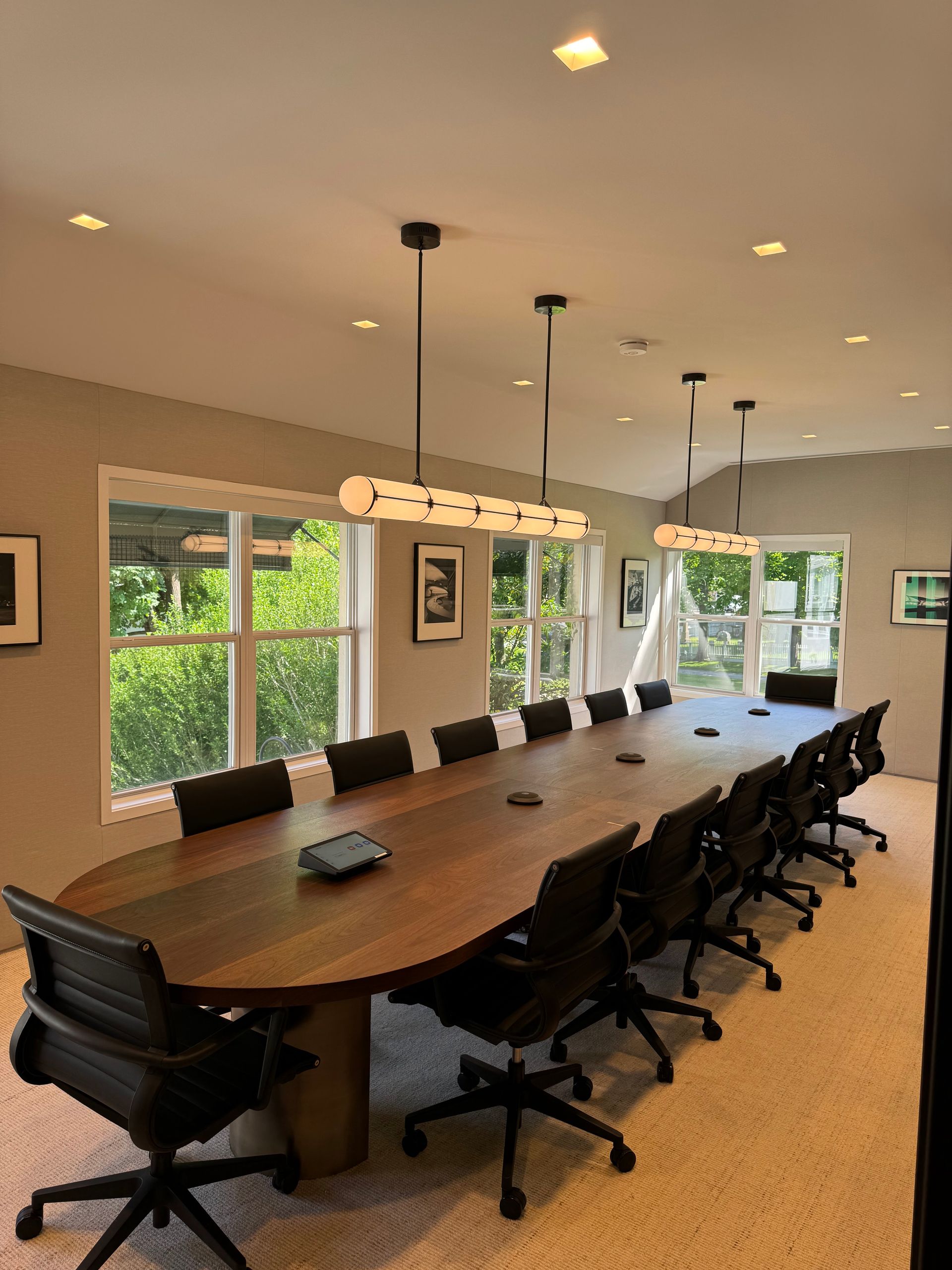 A conference room with a long table and chairs.