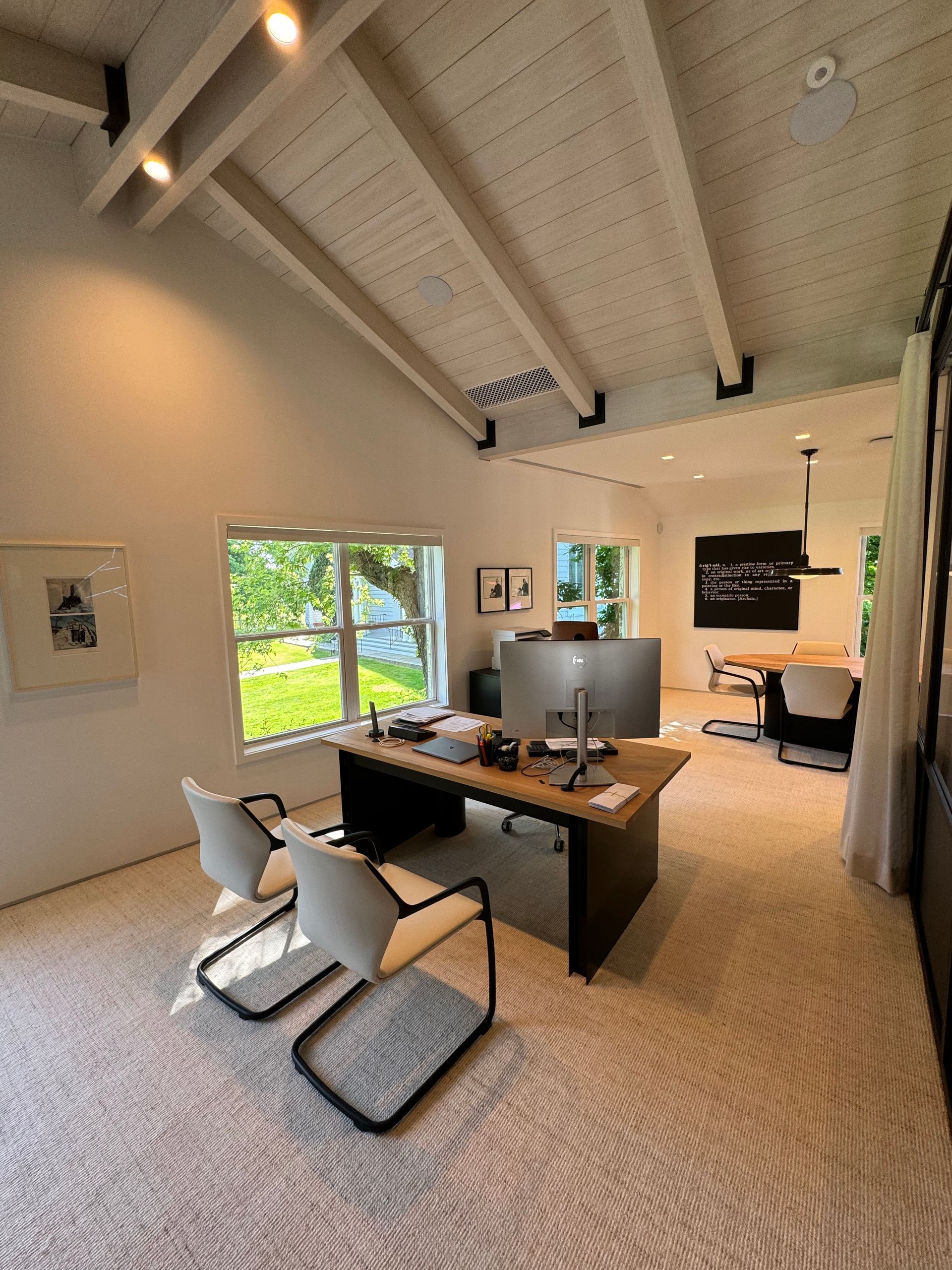 A large room with a desk and chairs in it