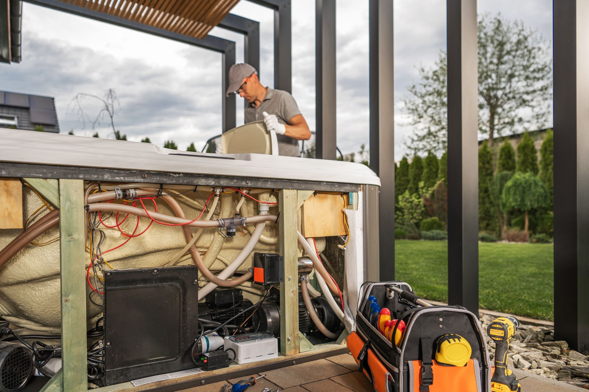 A man is working on the inside of a hot tub.
