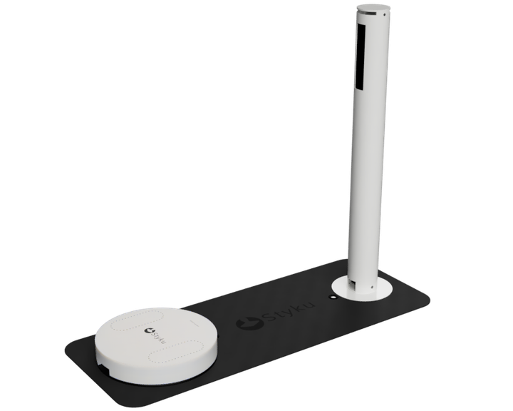 A white pole is sitting on top of a black mat