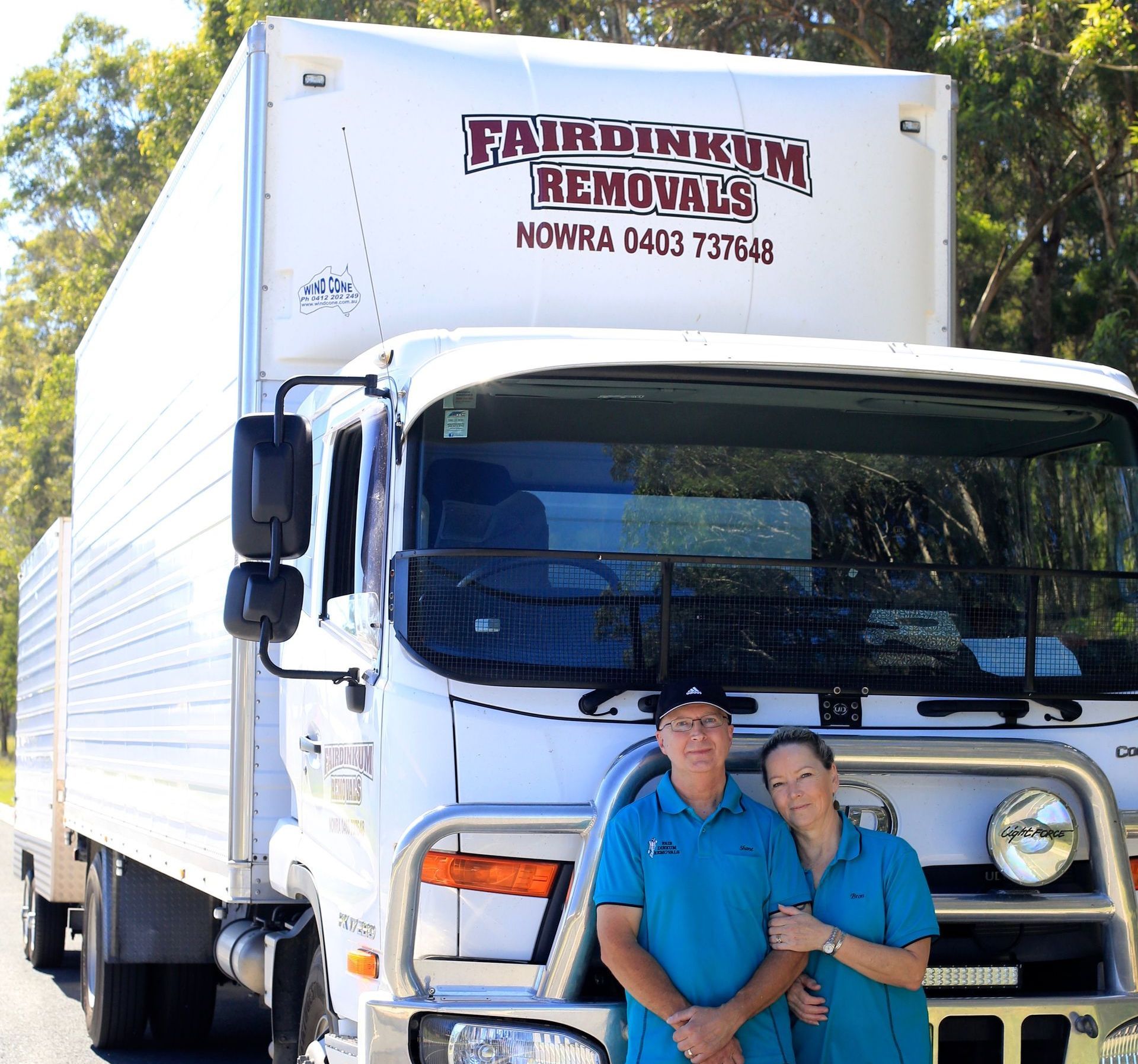 Two People Standing In Front Of A Fairdinkum Removals Truck — Fairdinkum Removals In Nowra, NSW