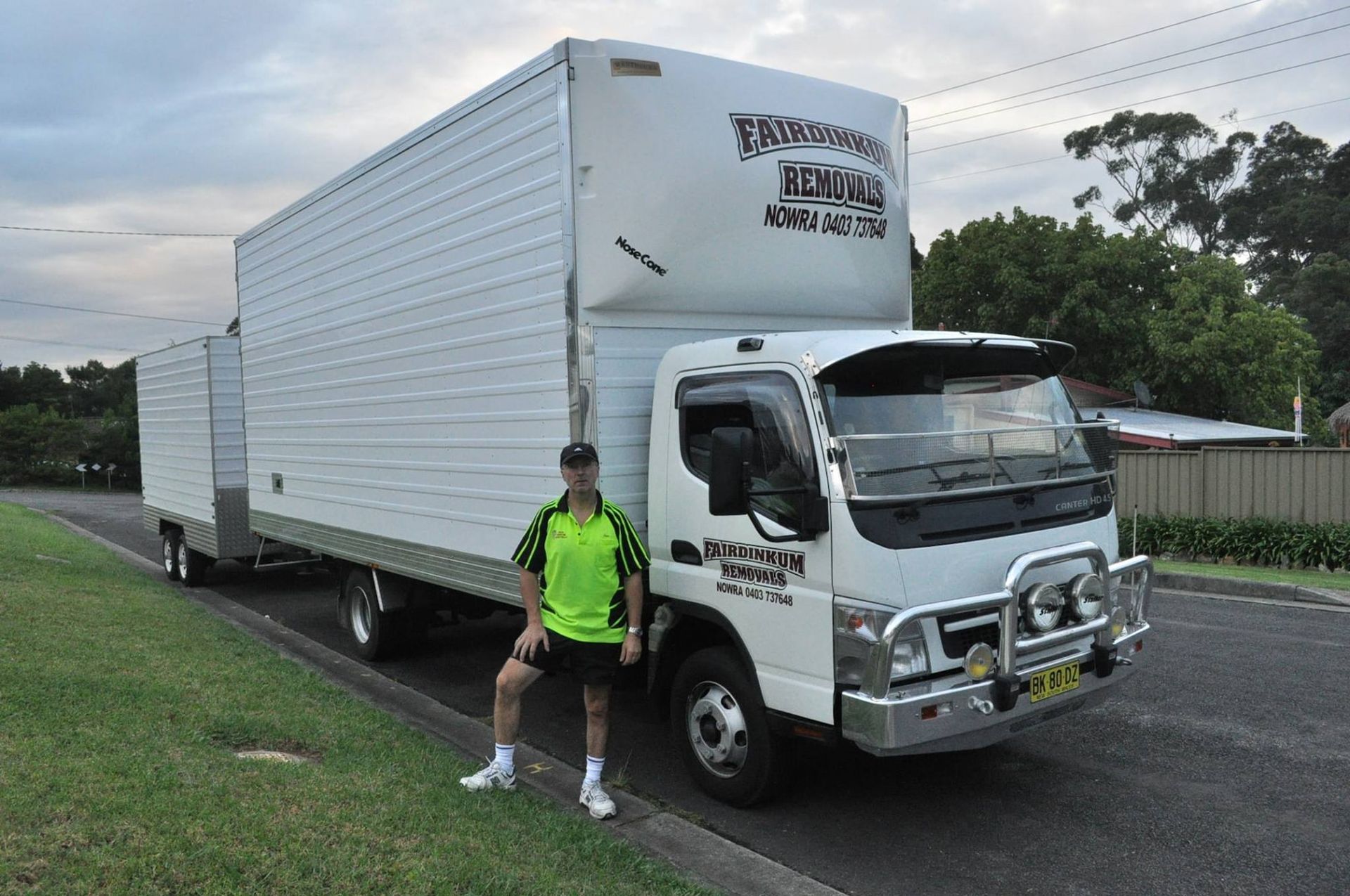 A Man Standing In Front Of A Moving Truck — Fairdinkum Removals In Nowra, NSW