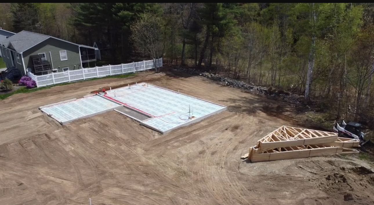An aerial view of a house under construction in the middle of a dirt field.