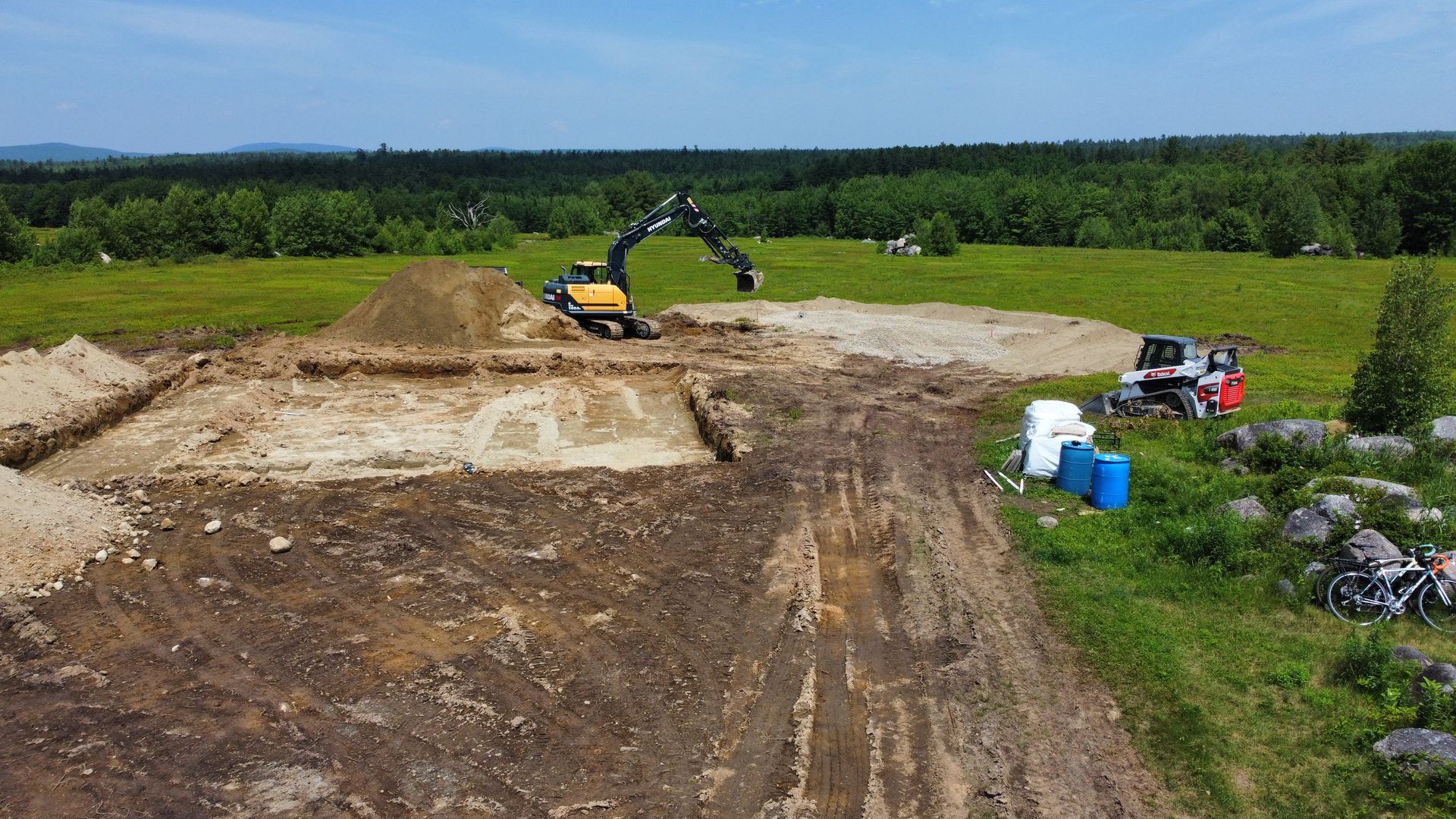 An aerial view of a construction site with a bulldozer digging in the dirt.