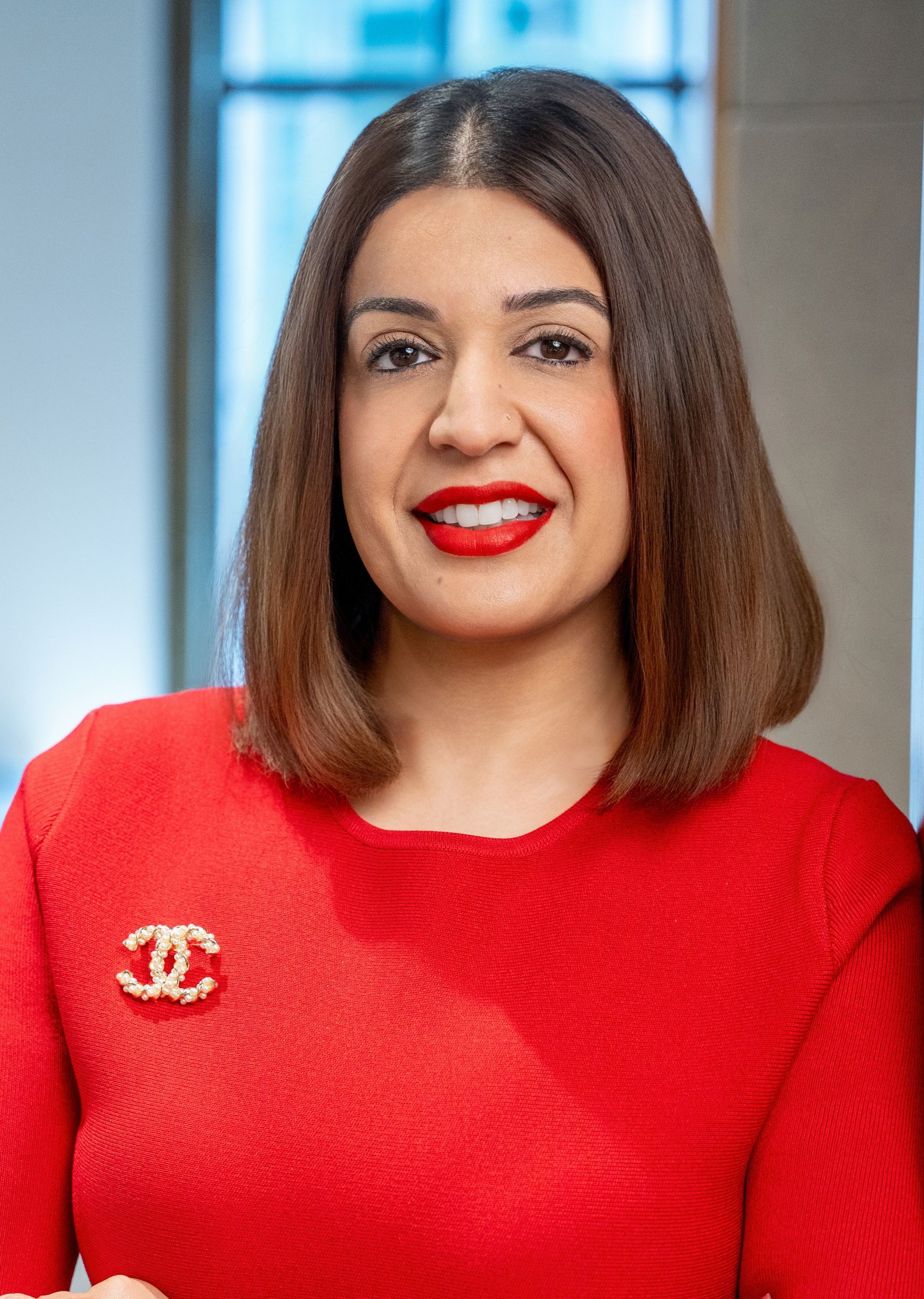 A man in a suit and tie is smiling for the camera.
