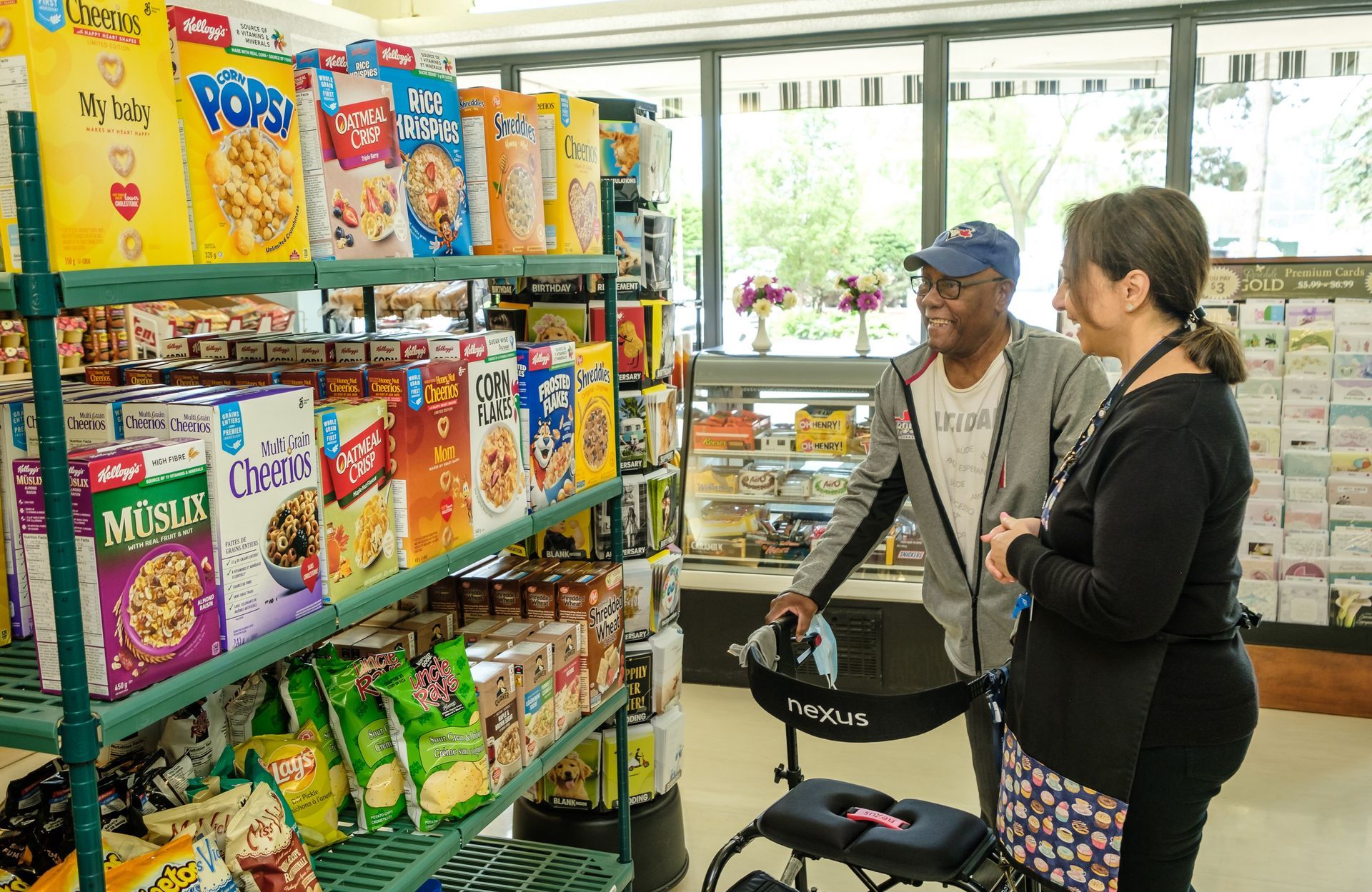 A man and a woman are shopping in a grocery store . the woman is using a walker.
