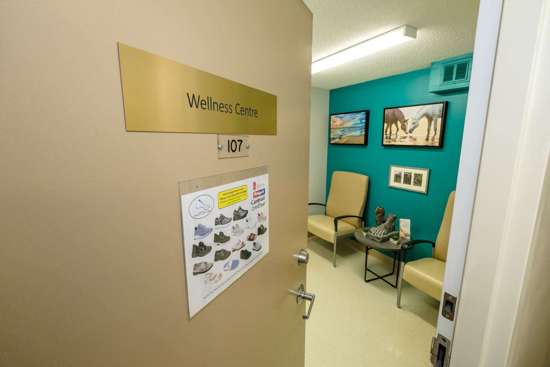 A waiting room with chairs and a sign that says wellness center