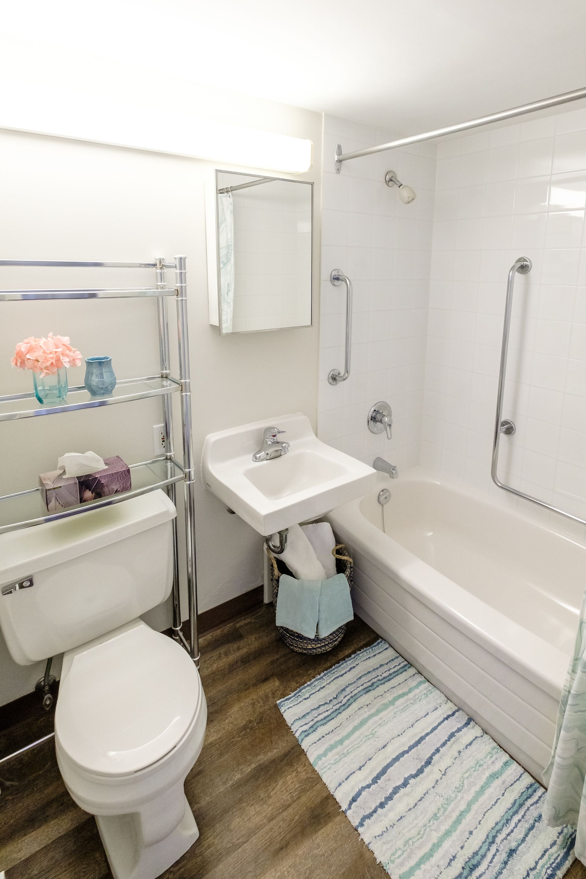 A bathroom with a toilet , sink , and bathtub.