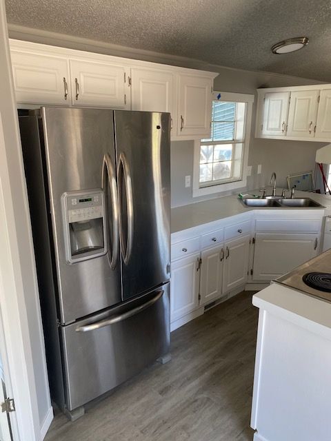 A kitchen with stainless steel appliances and white cabinets