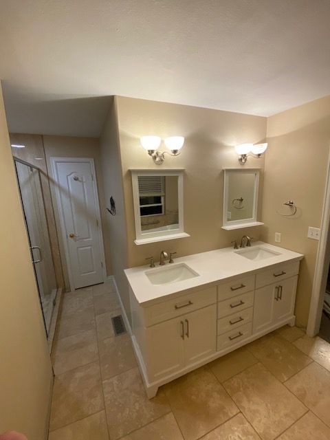 A bathroom with two sinks and two mirrors