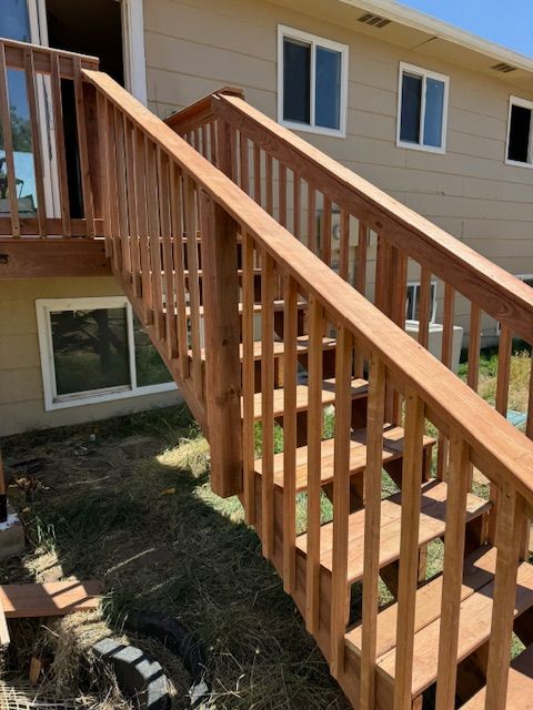 A set of wooden stairs leading up to a house