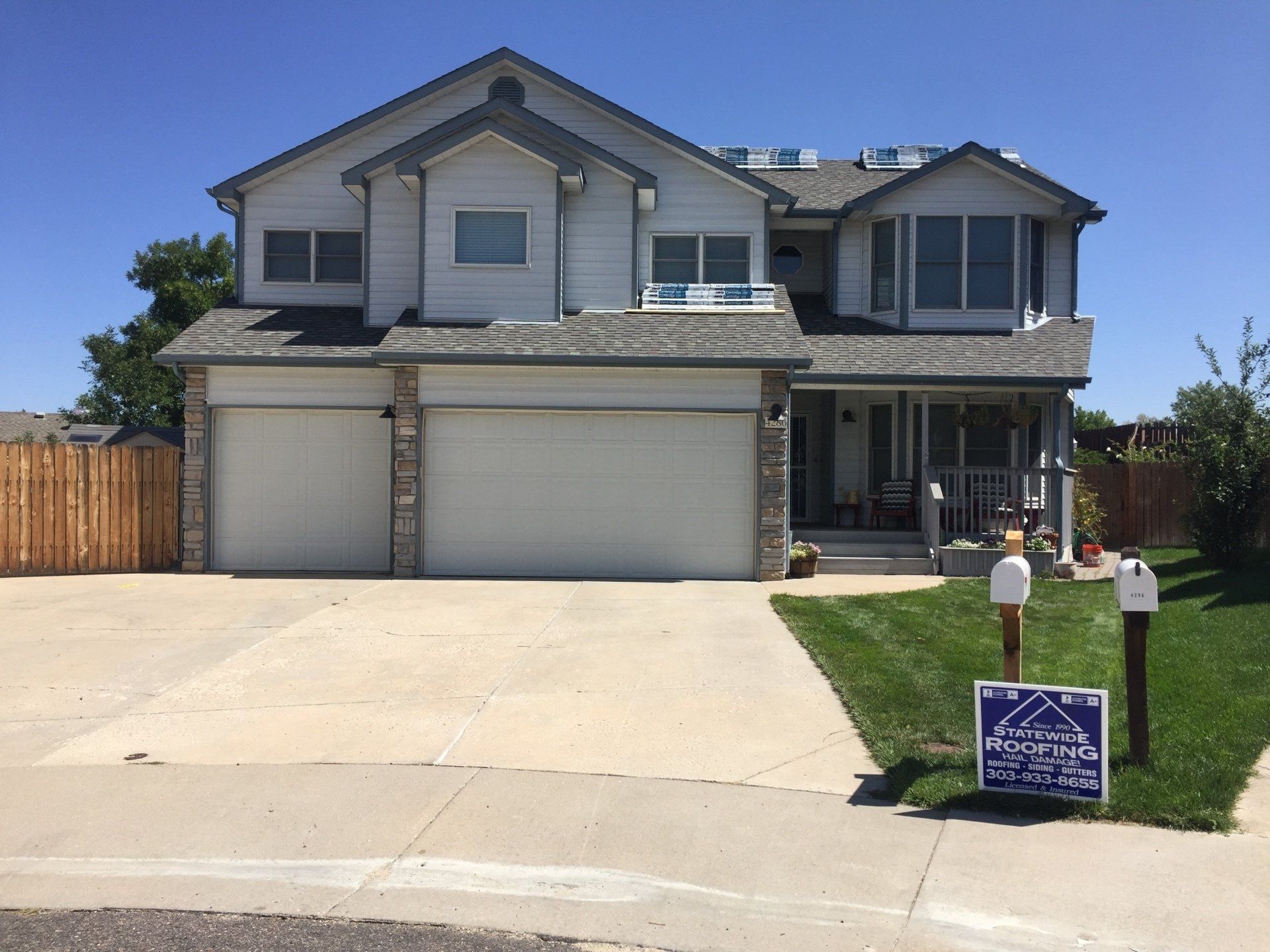 a large white house with a for sale sign in front of it