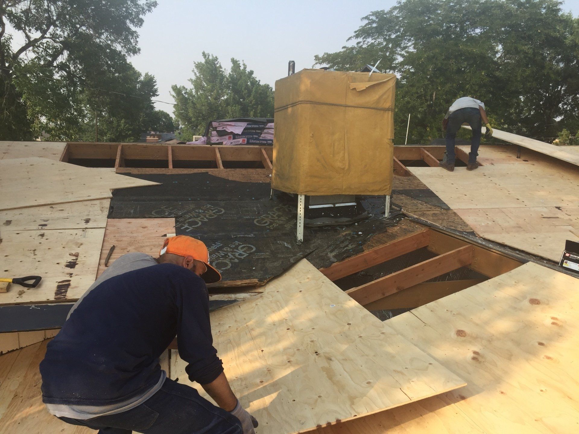 a man working on the roof of a house