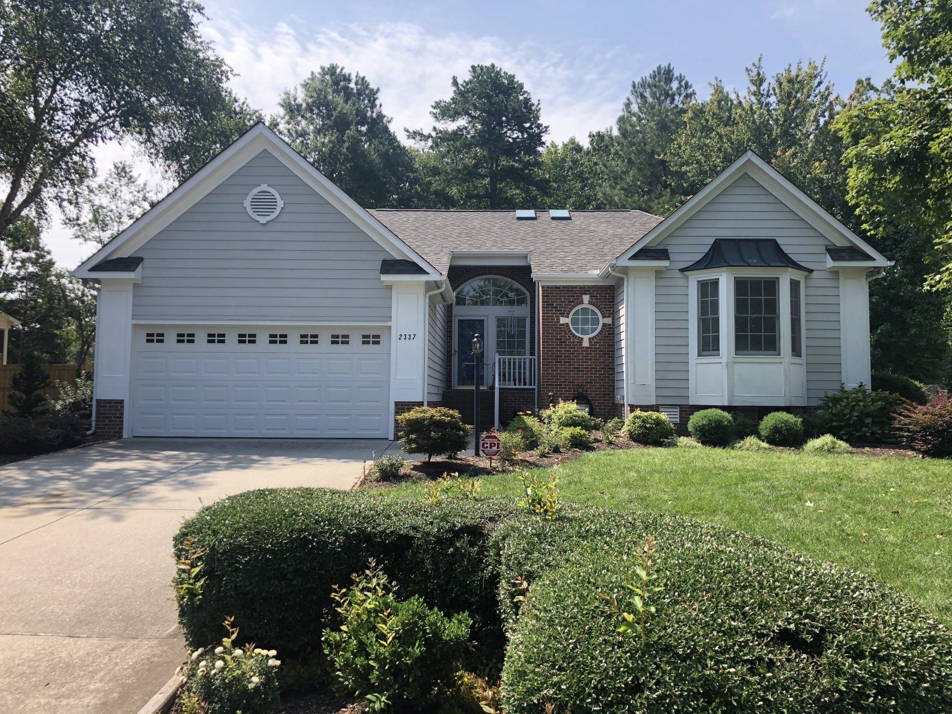 a white house with a large white garage door