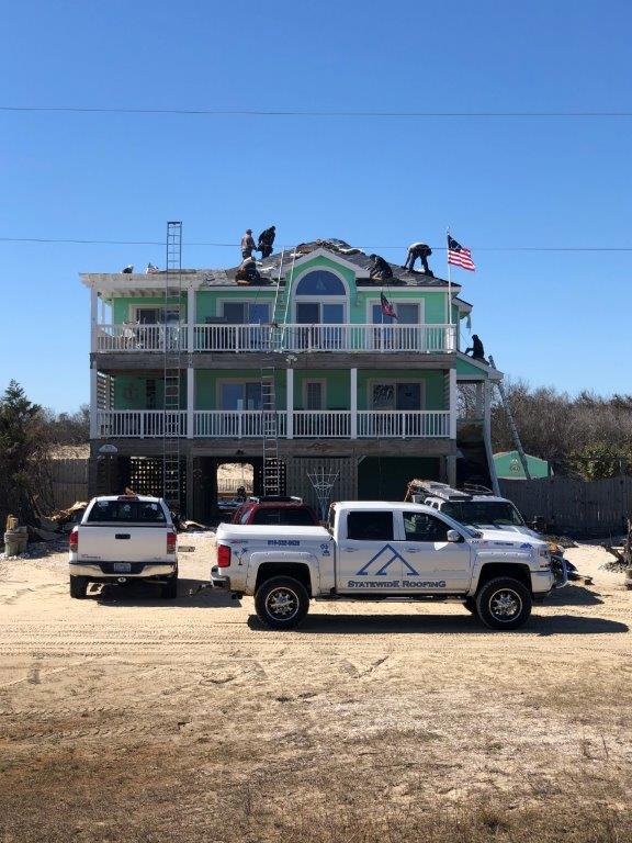 a large house with a truck parked in front of it .