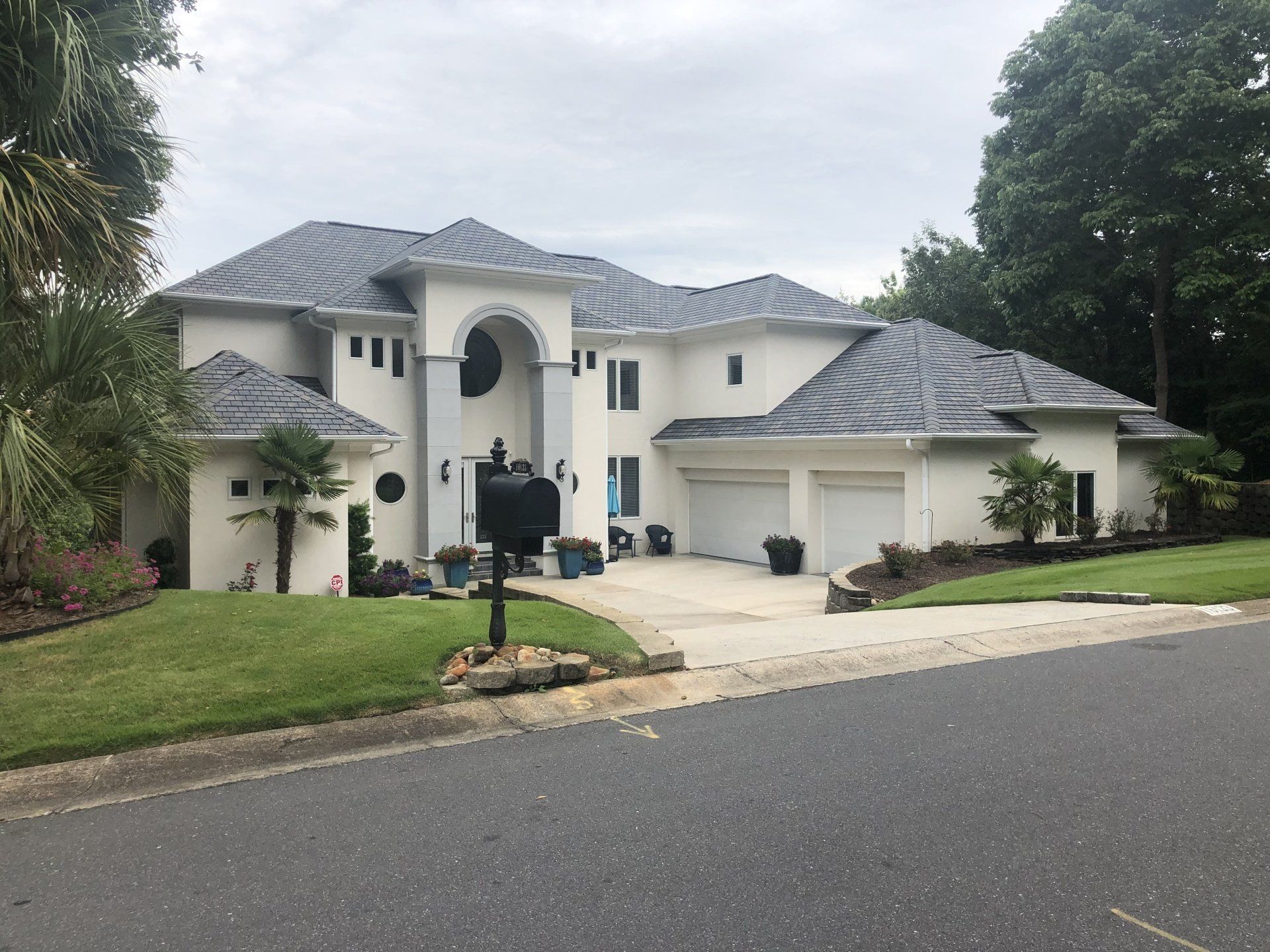 a large white house with a black mailbox in front of it .