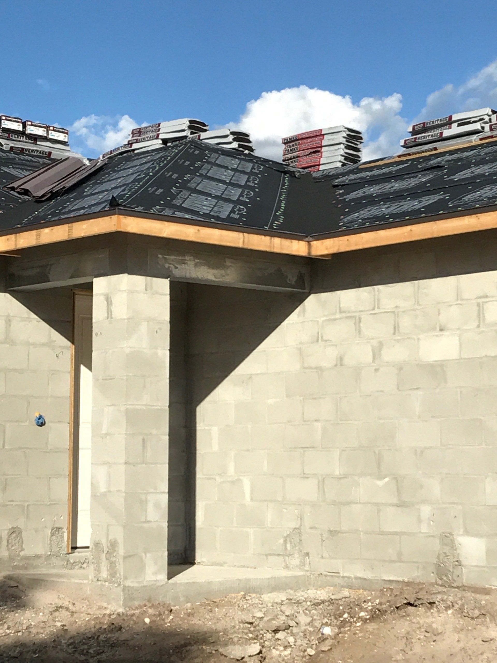 a brick building with a roof that is being built .