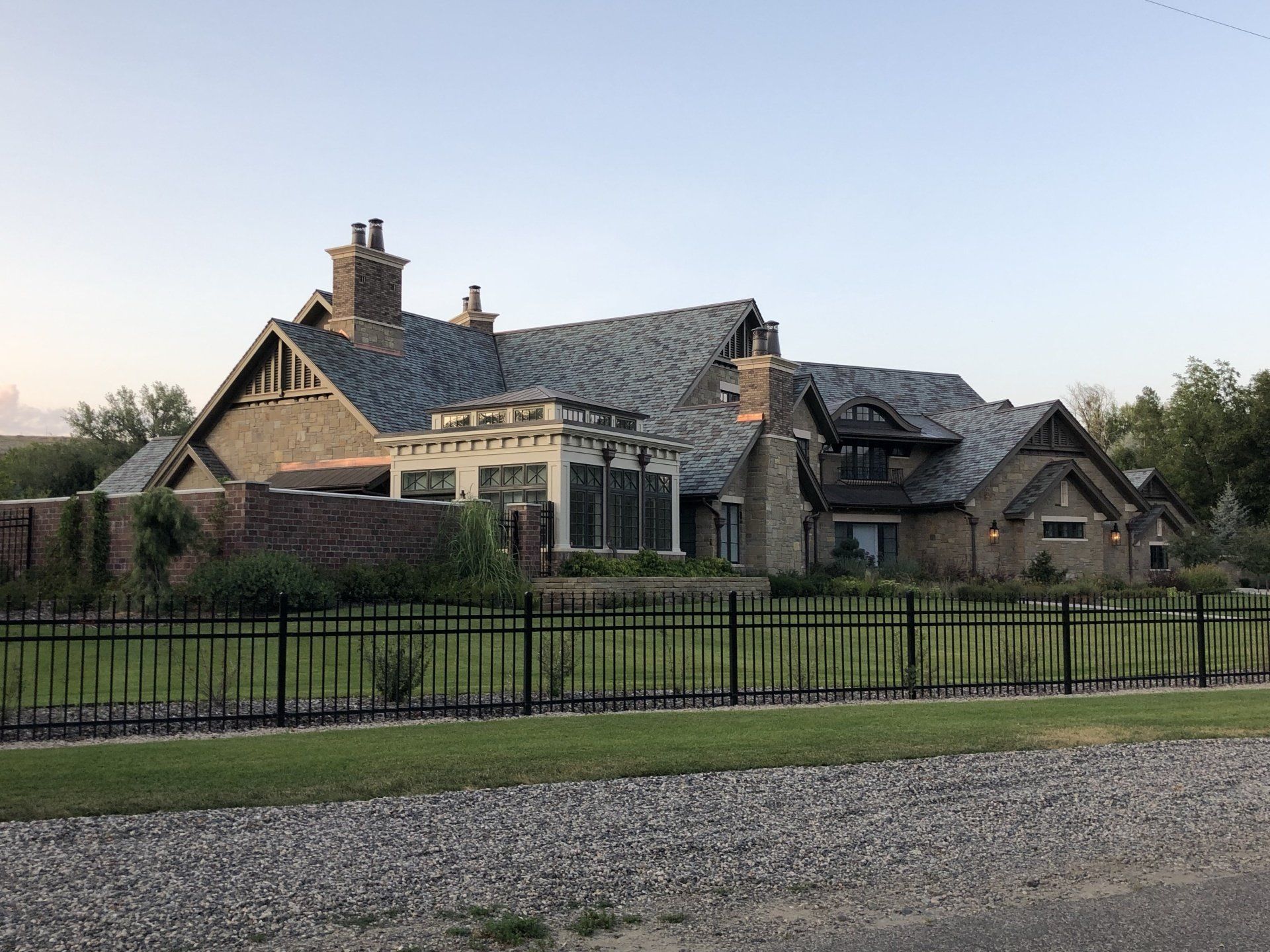 a large house with a fence in front of it .