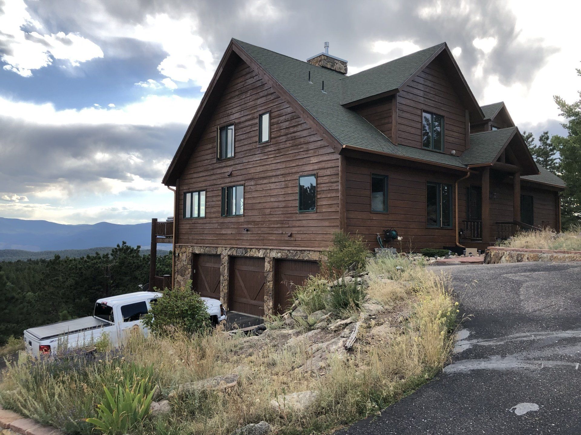 a large wooden house with a truck parked in front of it