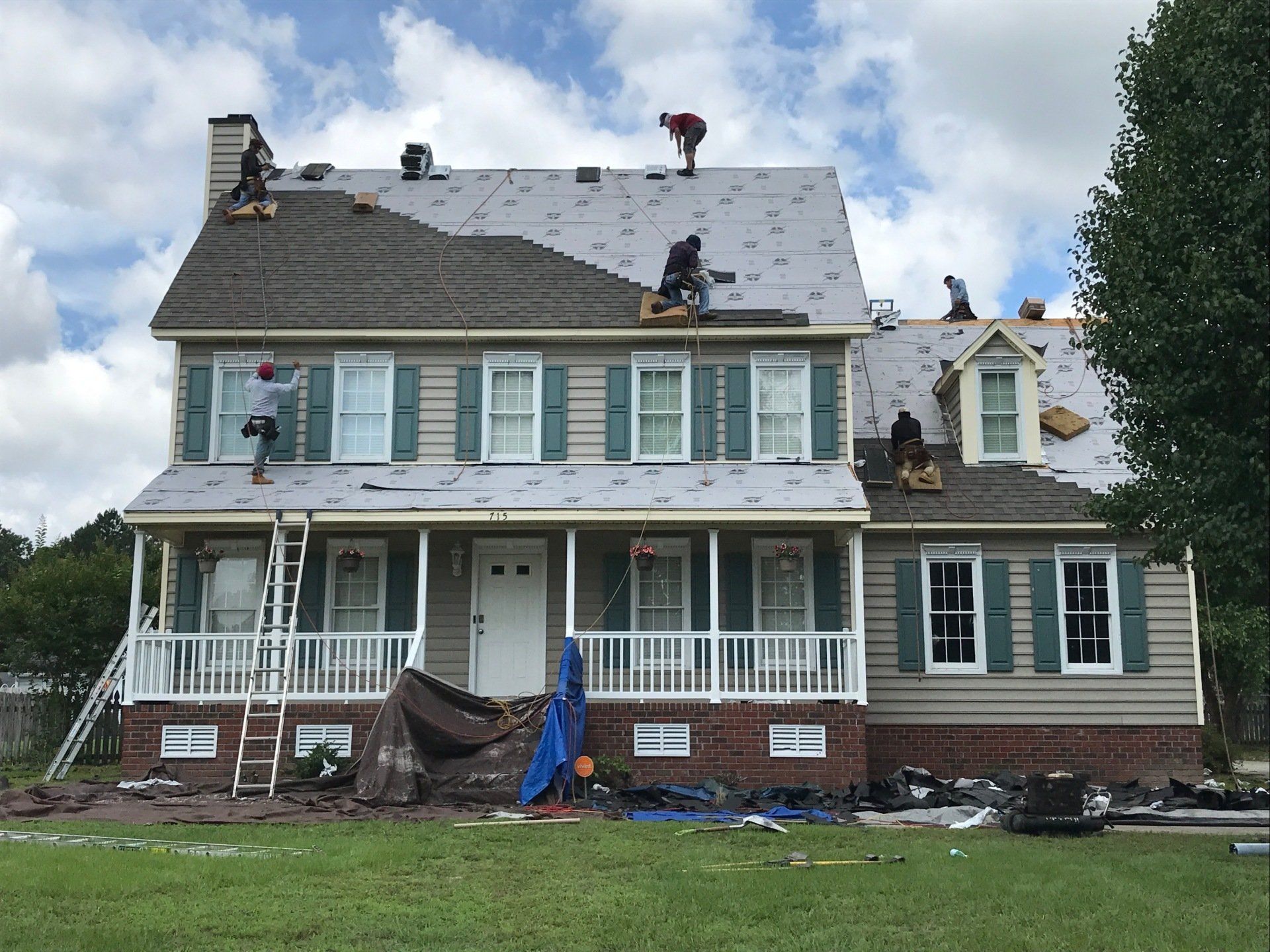 a house being remodeled with a roof being installed