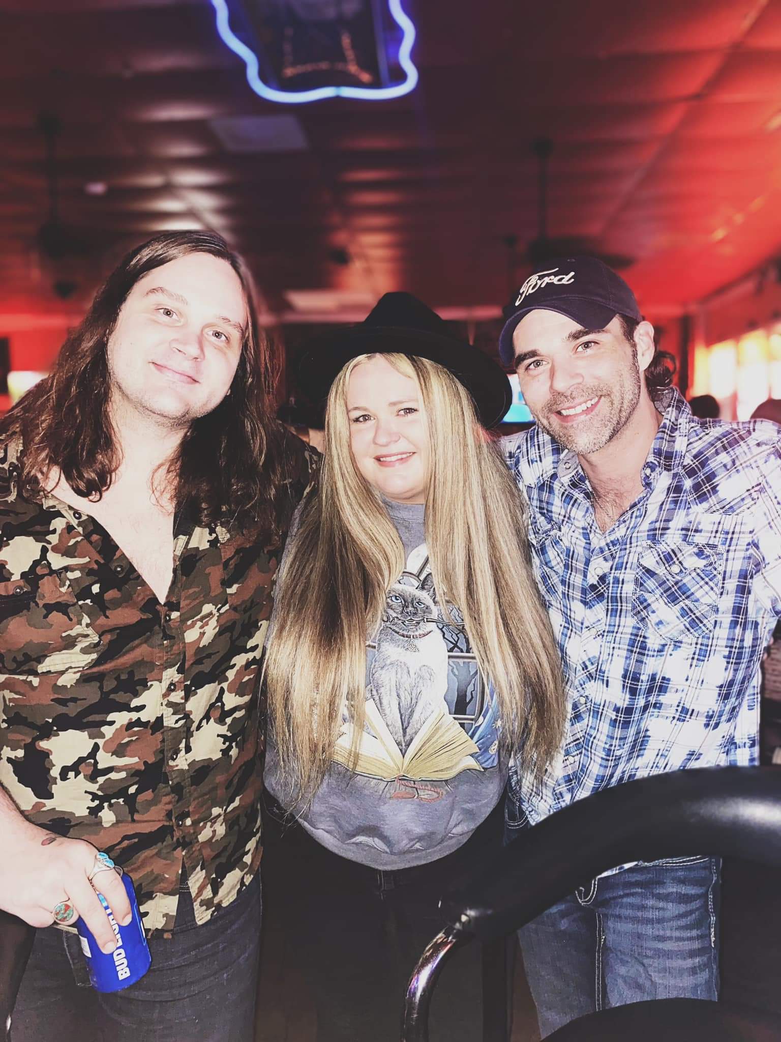 A group of people are posing for a picture in a bar.