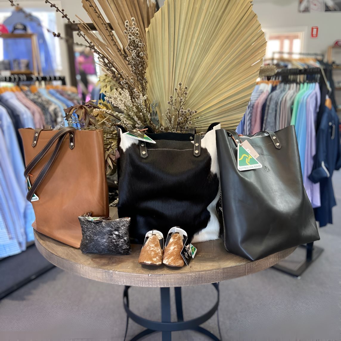 A Table With Handbags And Shoes On It In A Store — Shellie's Country Wear In Nabiac, NSW