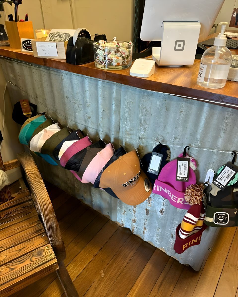 A Bunch Of Hats Are Hanging On A Wall In A Store — Shellie's Country Wear In Nabiac, NSW