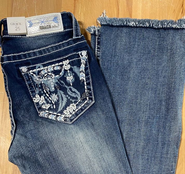 A Pair Of Jeans With A Floral Design On The Back Pocket — Shellie's Country Wear In Nabiac, NSW