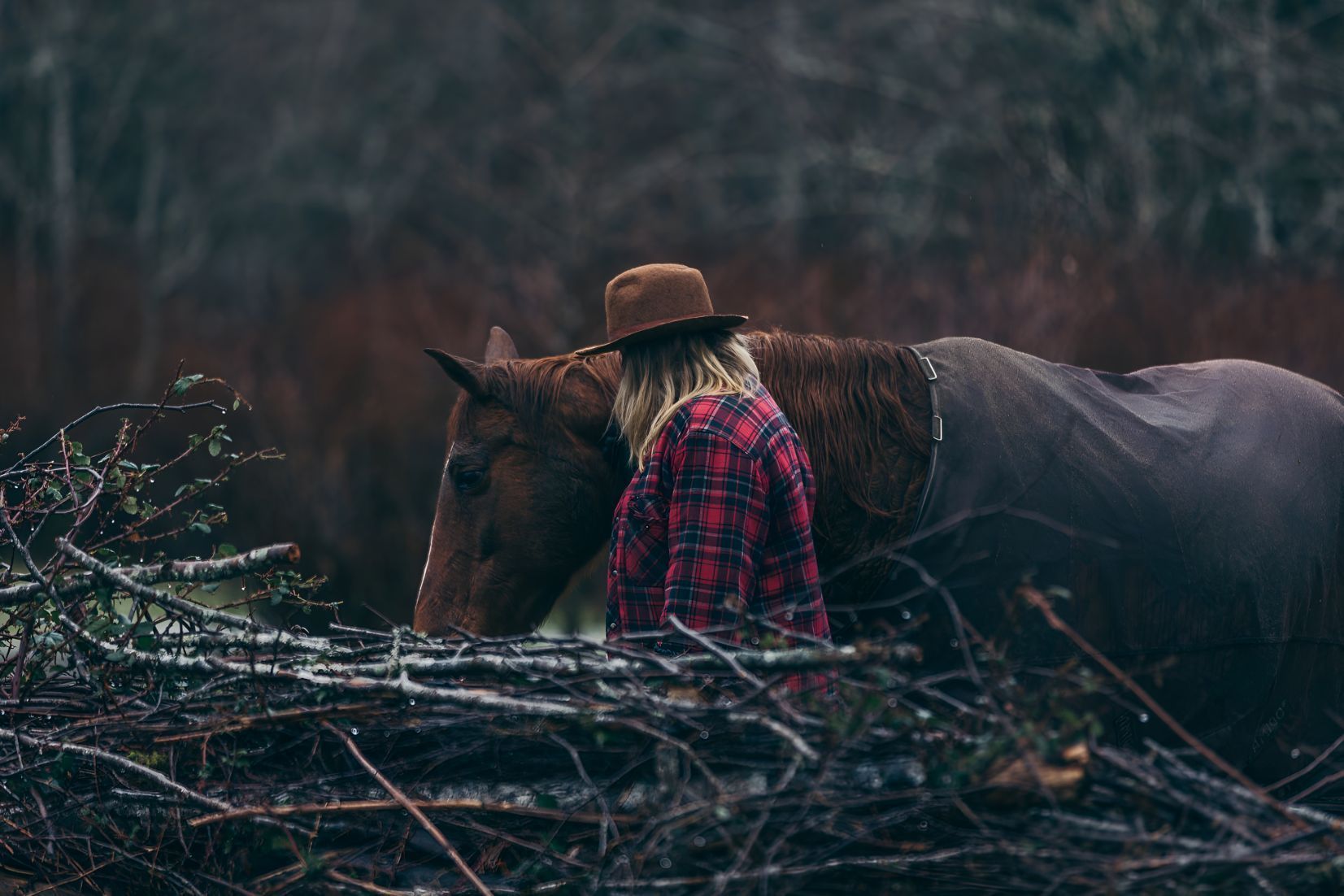 A Woman Is Standing Next To A Horse In The Woods — Shellie's Country Wear In Nabiac, NSW