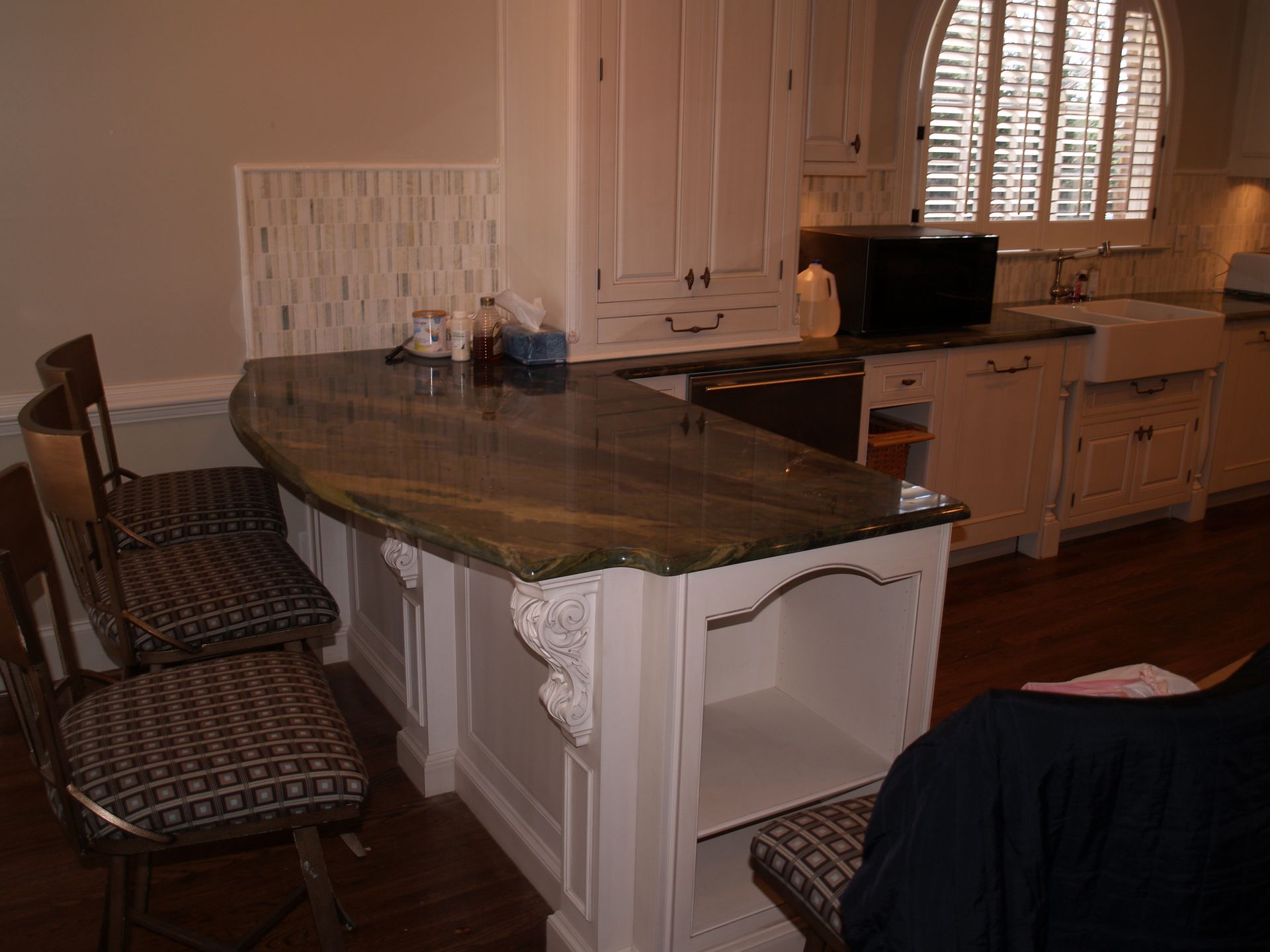 A kitchen under construction with a large island in the middle.