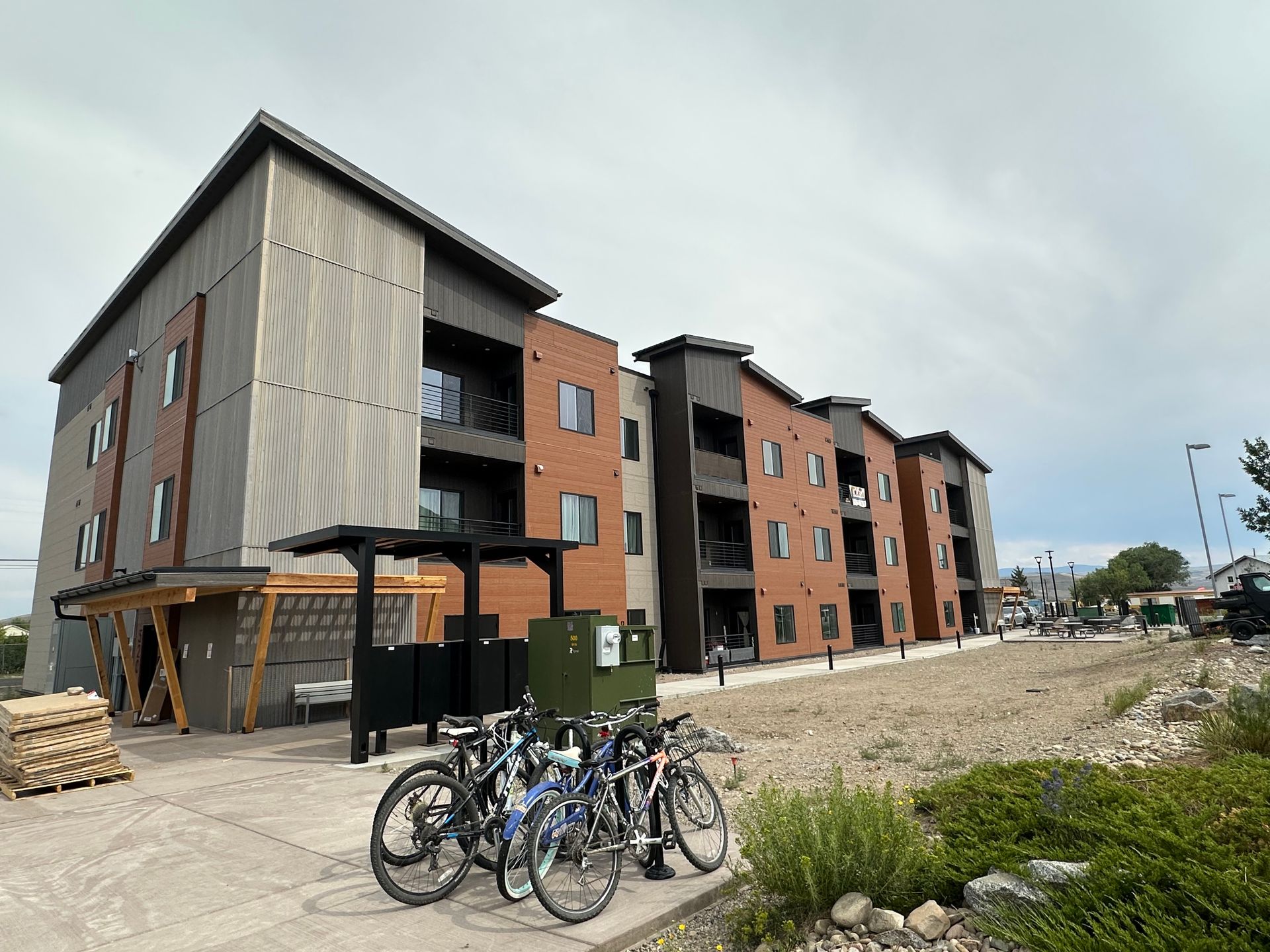 people around backhoes and mountains with snow