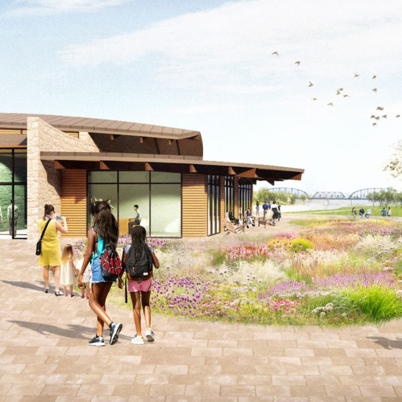 People walking near a building with glass windows, brown wood, and a wildflower garden over looking the Ohio River.