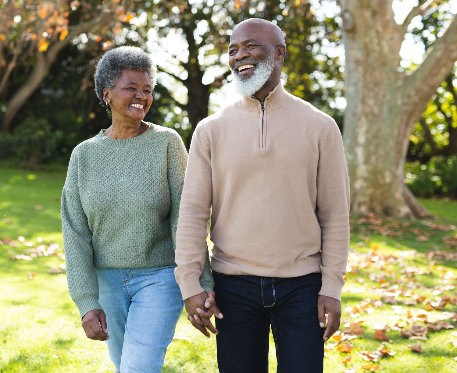 A man , woman and child are hugging each other and smiling.
