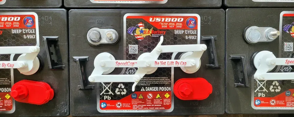 A bunch of batteries are sitting on top of each other on a table.