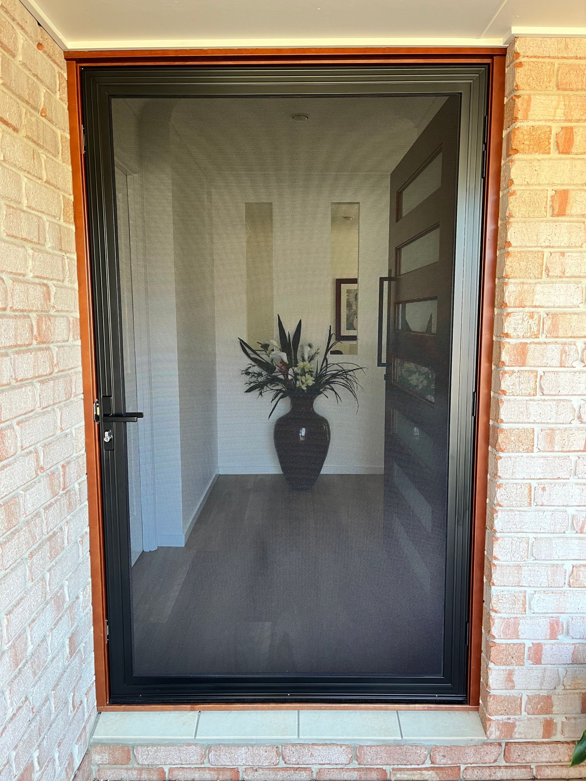 A Grey Building With Black Blinds On The Windows — Budget Home Improvements In Tweed Heads South, NSW