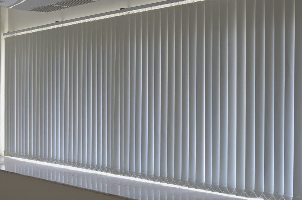 A Wall With Vertical Blinds On It In A Room — Budget Home Improvements In Tweed Heads South, NSW