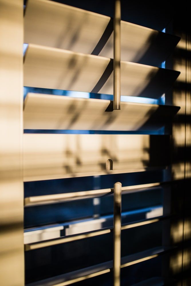 A Close Up Of A Window With Shutters On It — Budget Home Improvements In Tweed Heads South, NSW