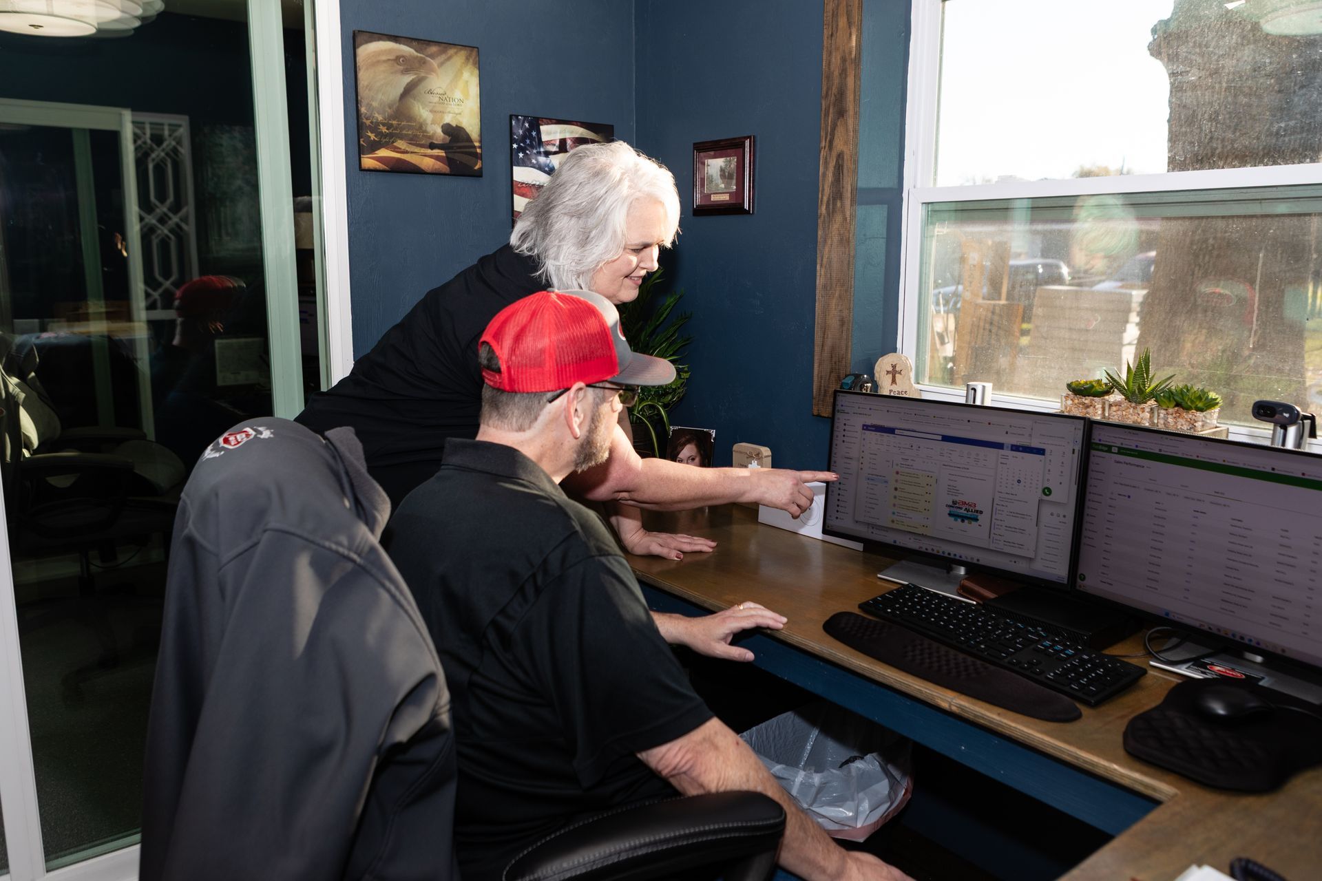Couple relaxes on a couch, looking at a tablet and smartphone in a living room.