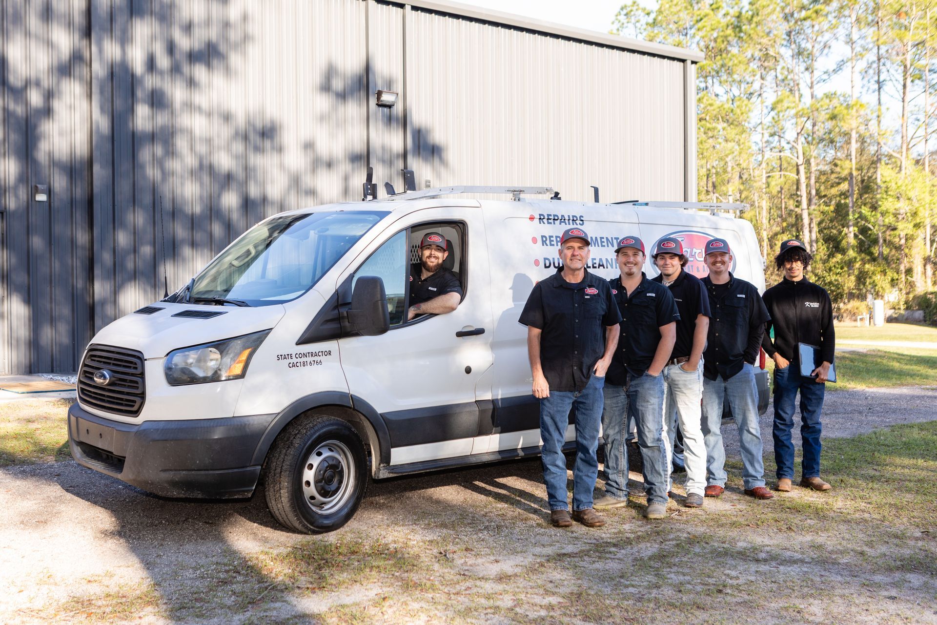 Group of people in front of a building, and a dog.