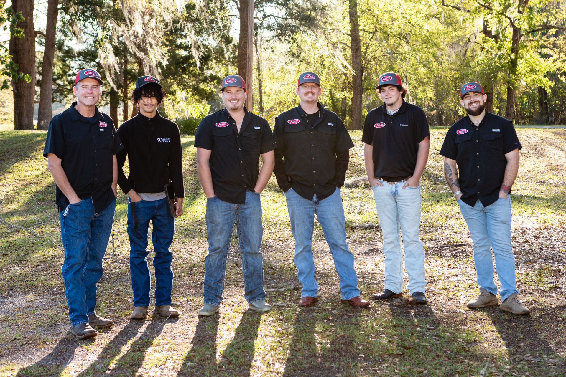 Woman examining an outdoor air conditioning unit on a balcony overlooking a coastal town.