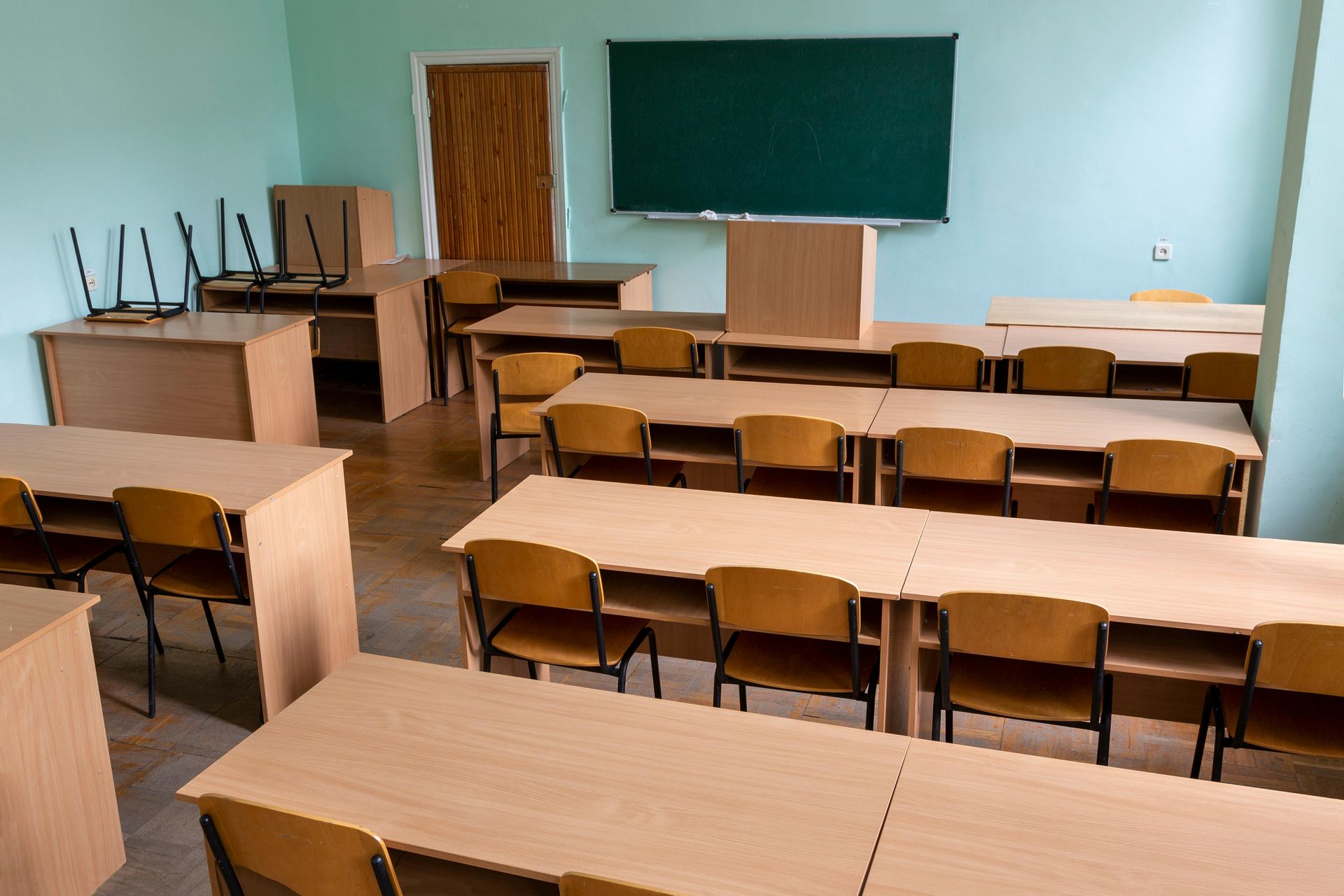 Blue school room with wooden desks