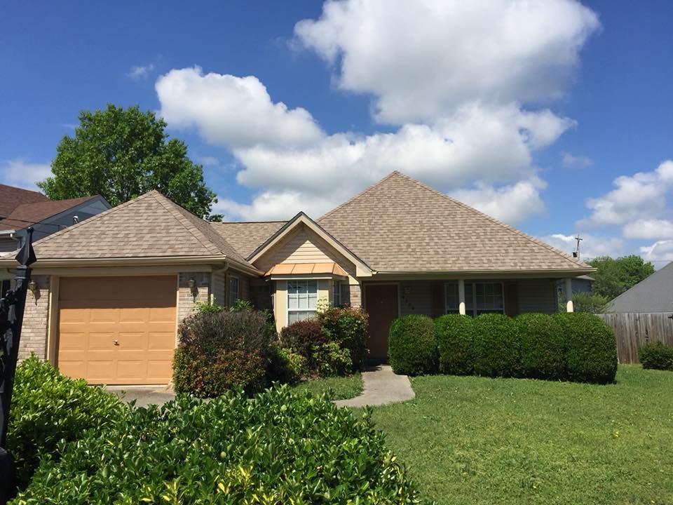 a house with a brown roof and a yellow garage door