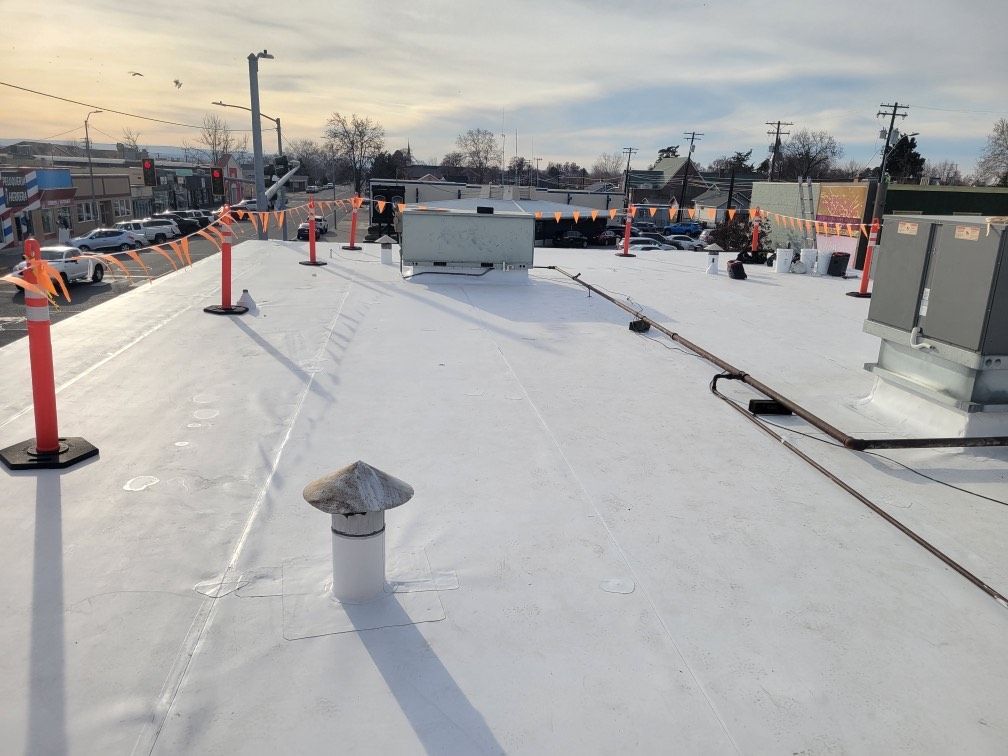 two men are working on the roof of a house
