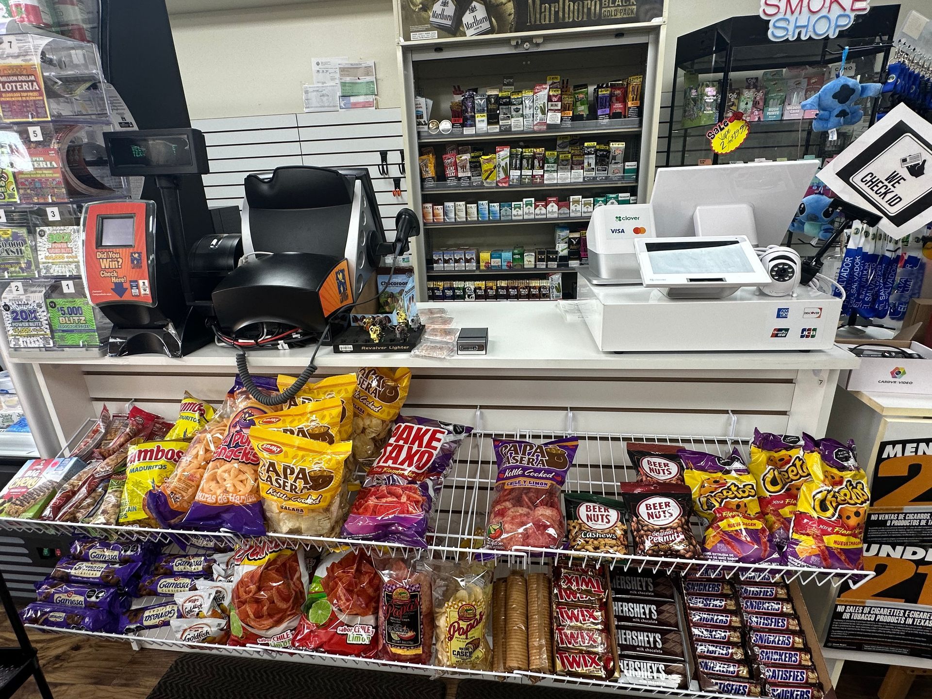 A convenience store counter with snacks, a gaming chair, and merchandise.