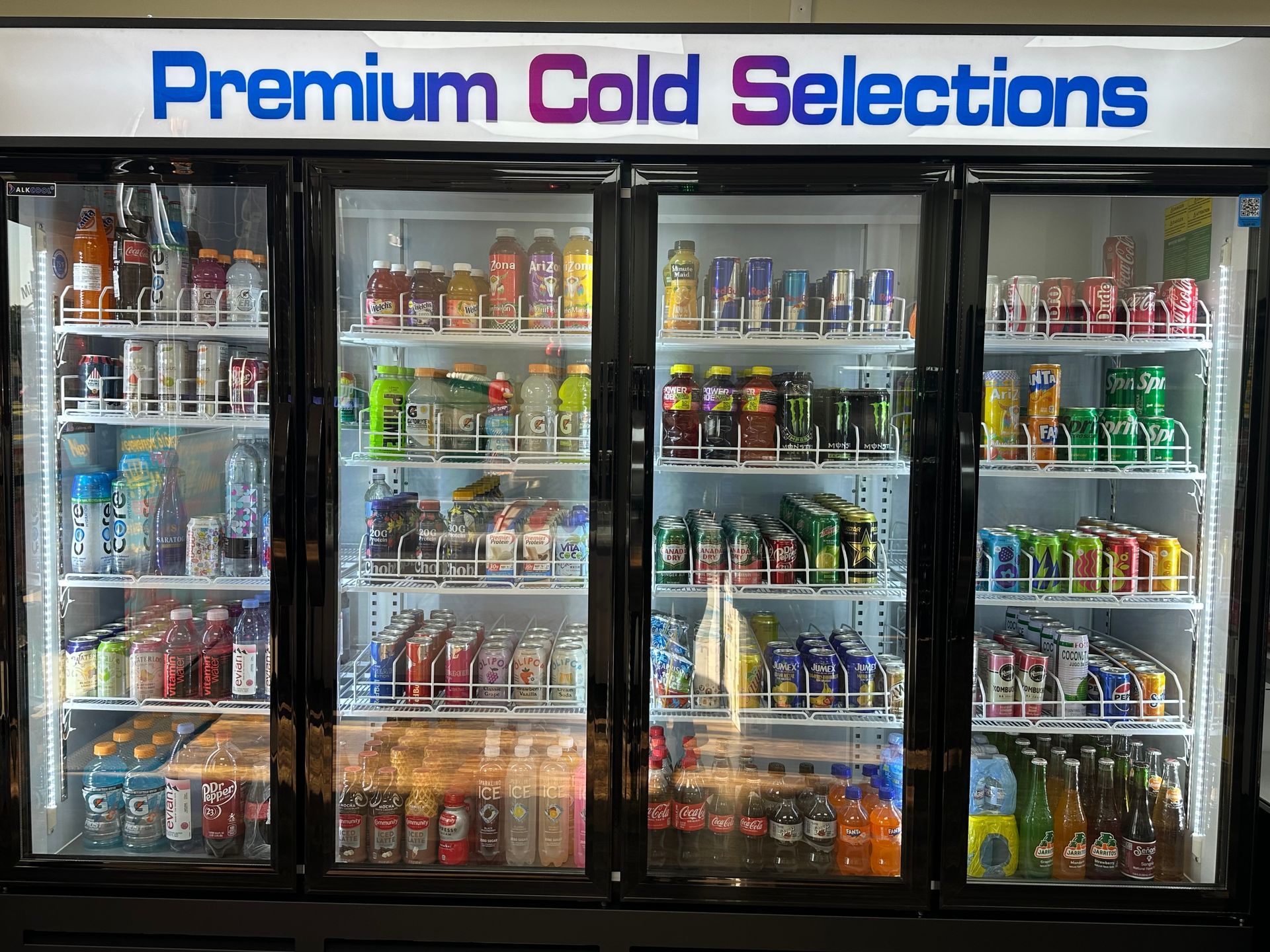Refrigerated display case filled with various cold beverages, including juices and sodas.