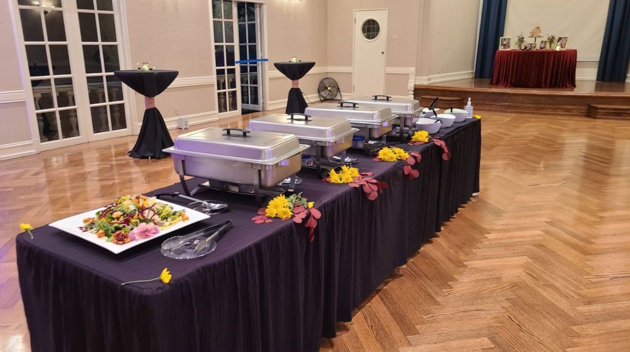 A long table with a lot of food on it in a room.