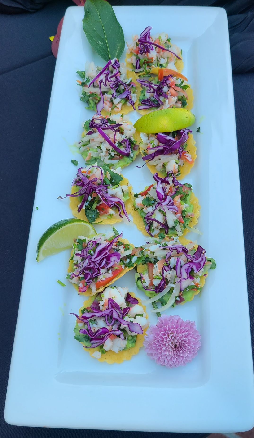 A white plate topped with a variety of vegetables and a flower.