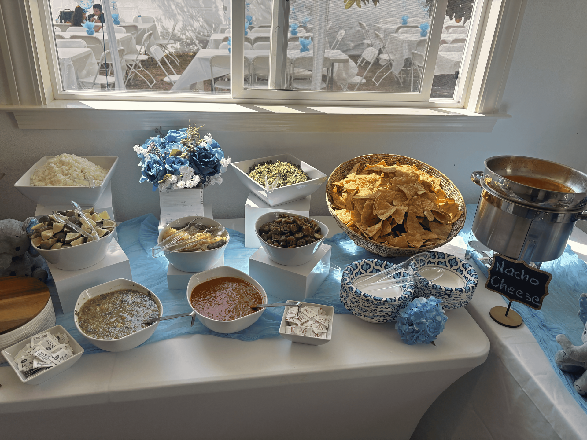 A buffet table with a variety of food on it.