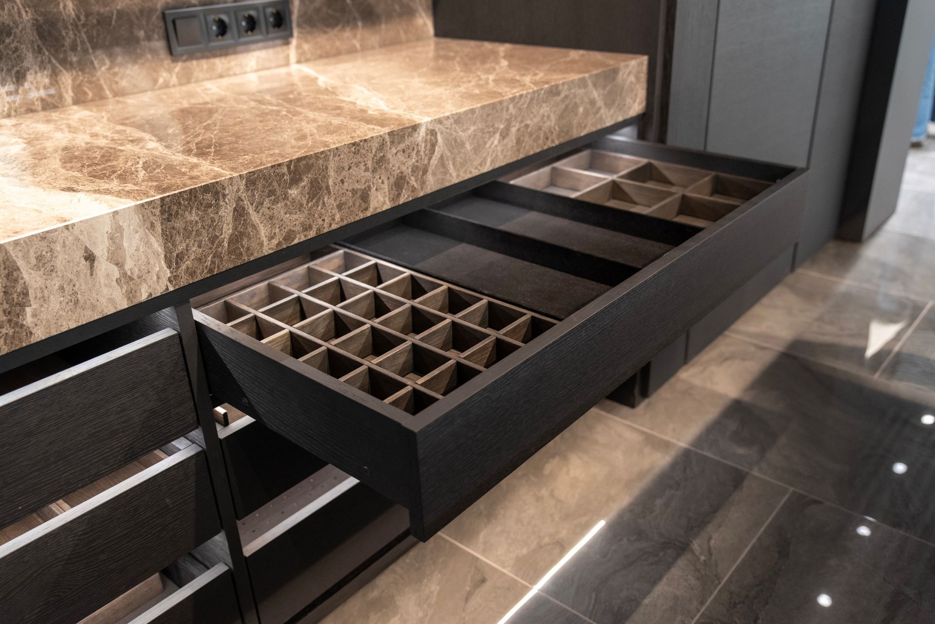 A drawer in a kitchen with a tray in it.