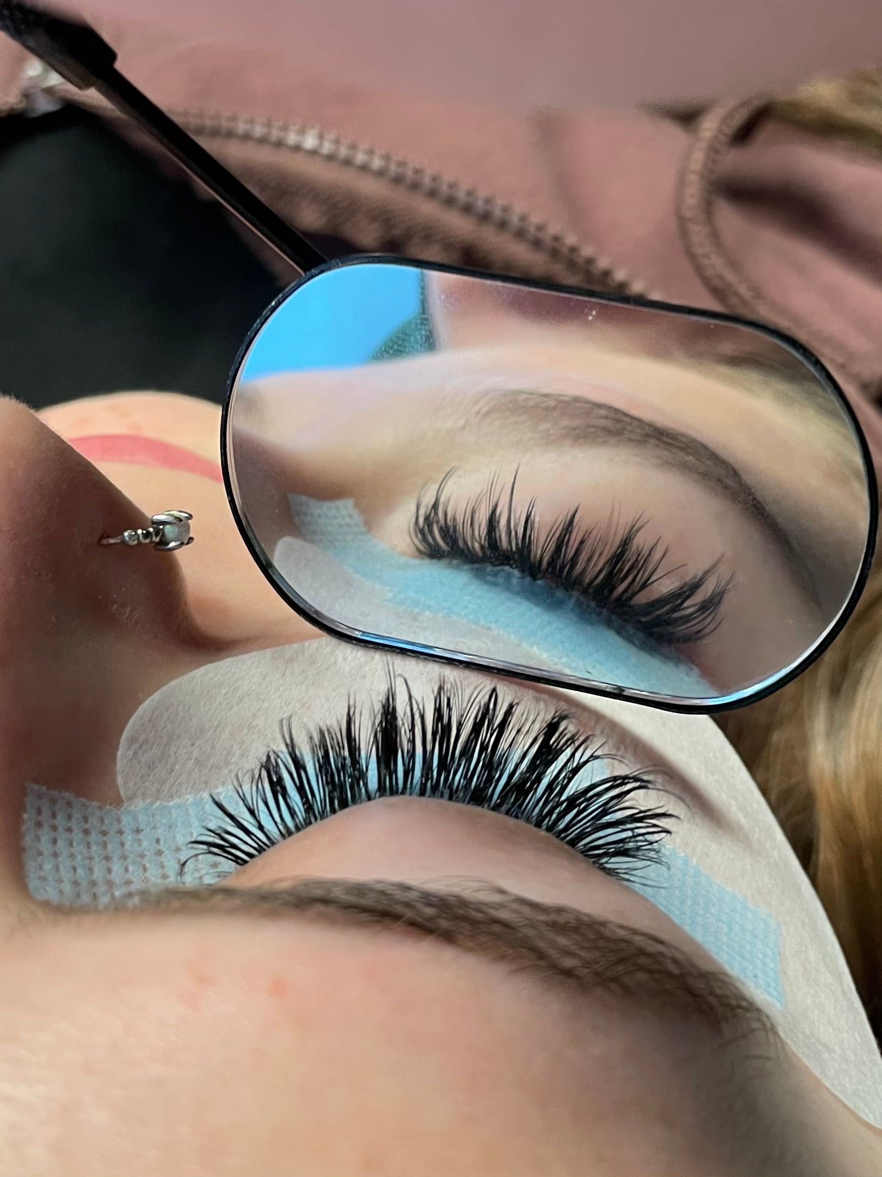 A close up of a woman 's eye with glasses on
